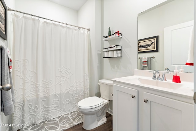 bathroom featuring wood-type flooring, vanity, and toilet