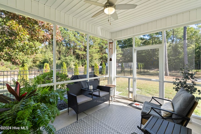 sunroom / solarium featuring a wealth of natural light and ceiling fan