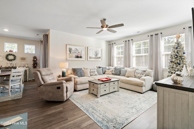 living room featuring light hardwood / wood-style flooring and ceiling fan