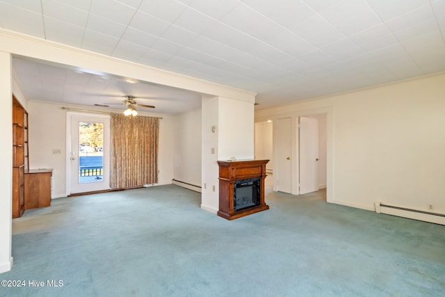 unfurnished living room featuring baseboard heating, crown molding, carpet flooring, and ceiling fan