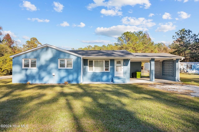 ranch-style home featuring a carport and a front yard