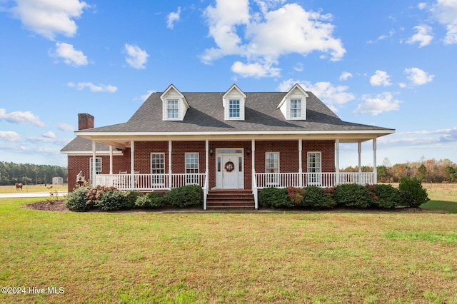 farmhouse with a porch and a front lawn