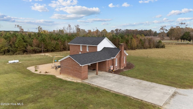 1221 NC Highway 305, Aulander, NC 27805 - view of home's exterior with concrete driveway, brick siding, an attached carport, a chimney, and a yard