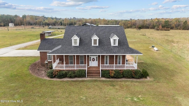 1221 NC Highway 305, Aulander, NC 27805 - cape cod-style house featuring brick siding, covered porch, a front yard, a chimney, and a shingled roof