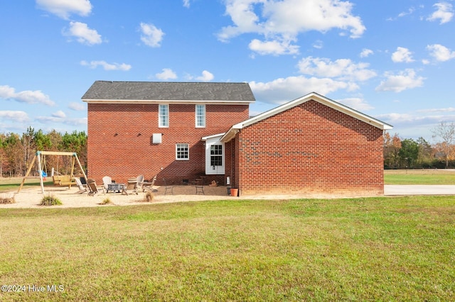 1221 NC Highway 305, Aulander, NC 27805 - rear view of property with a patio, a yard, brick siding, and a fire pit