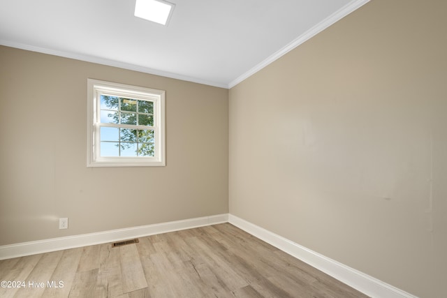 unfurnished room with light hardwood / wood-style flooring and ornamental molding