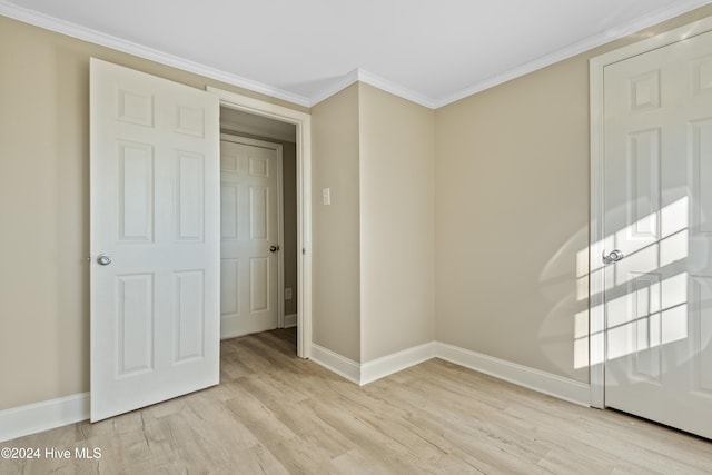 interior space with light hardwood / wood-style floors and ornamental molding