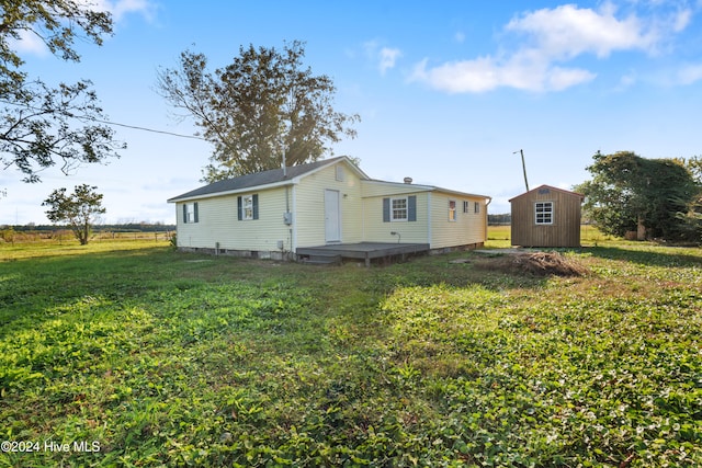 view of property exterior featuring a yard and a storage unit