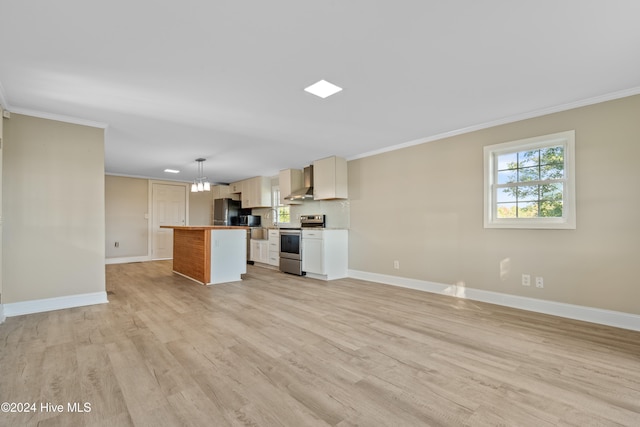 kitchen featuring decorative light fixtures, stainless steel appliances, a kitchen island, and light hardwood / wood-style floors