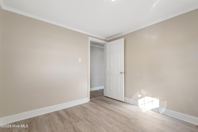 unfurnished bedroom featuring light hardwood / wood-style flooring and ornamental molding