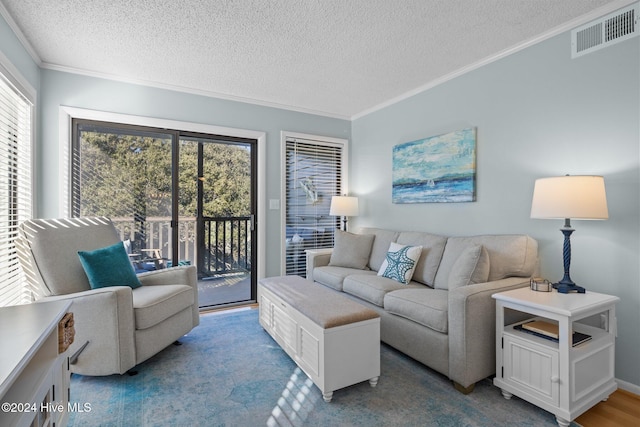 living room with a healthy amount of sunlight, crown molding, light colored carpet, and a textured ceiling