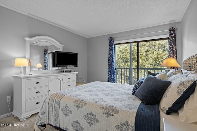 carpeted bedroom featuring access to exterior, a textured ceiling, and ornamental molding