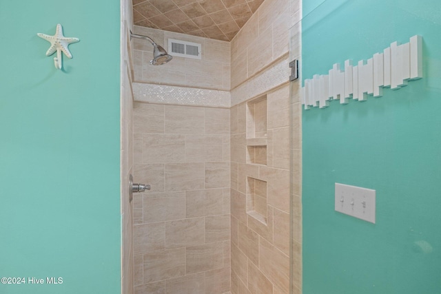 bathroom with tiled shower