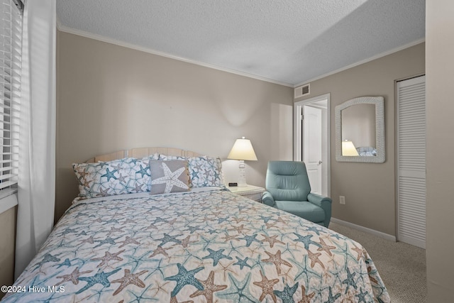 carpeted bedroom featuring ornamental molding and a textured ceiling