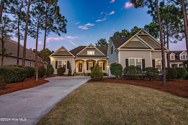 view of front of home with a porch and a yard