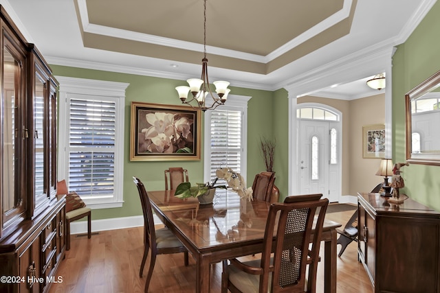 dining area featuring a notable chandelier, ornamental molding, and a wealth of natural light