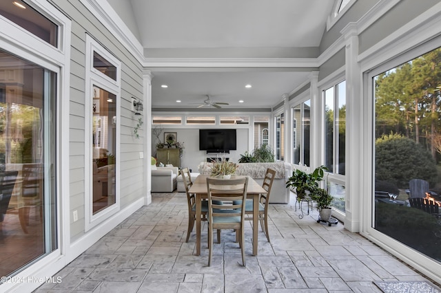 sunroom / solarium with ceiling fan and lofted ceiling