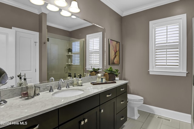 bathroom with crown molding, plenty of natural light, vanity, and a shower with shower door