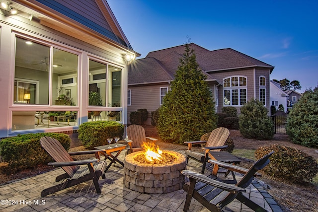 patio terrace at dusk featuring a fire pit