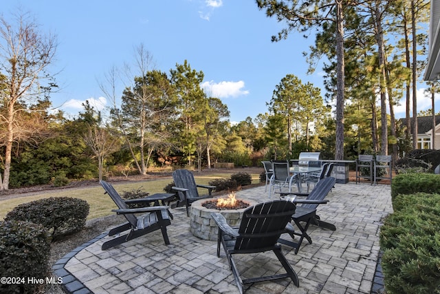 view of patio / terrace featuring an outdoor fire pit