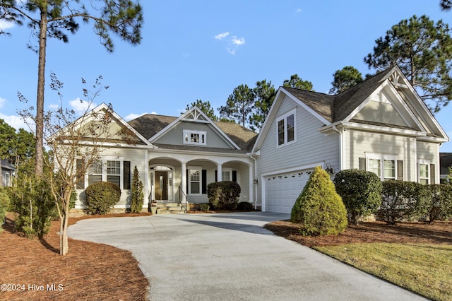 view of front of property featuring covered porch and a garage