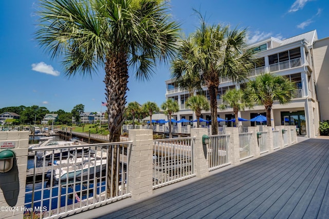 deck with a dock and a water view