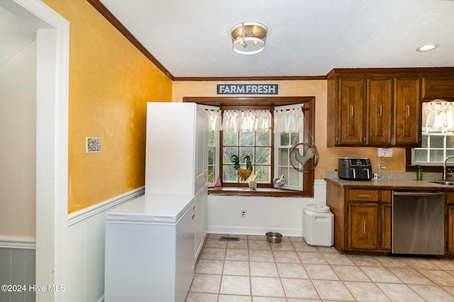 kitchen with sink, stainless steel dishwasher, a textured ceiling, light tile patterned floors, and ornamental molding