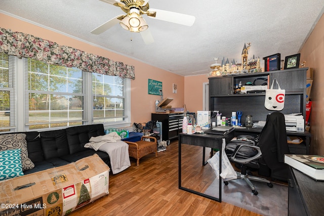 home office with ceiling fan, ornamental molding, a textured ceiling, and hardwood / wood-style flooring