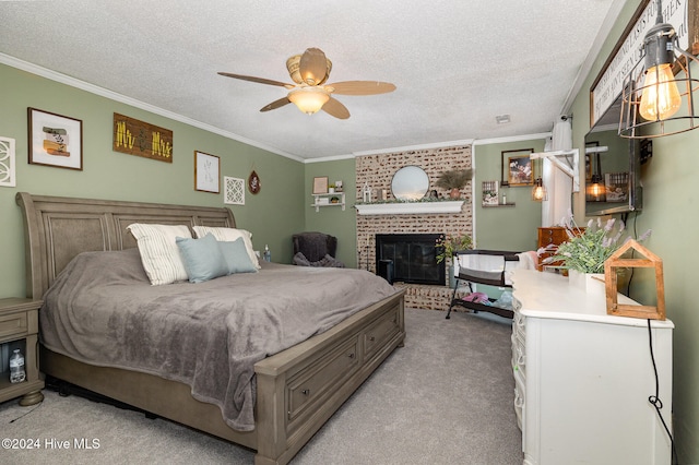 carpeted bedroom featuring a textured ceiling, a brick fireplace, ceiling fan, and crown molding