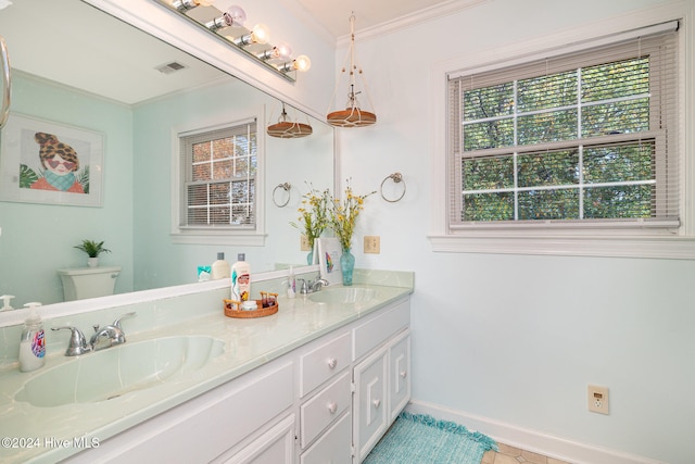 bathroom with a wealth of natural light, toilet, vanity, and ornamental molding