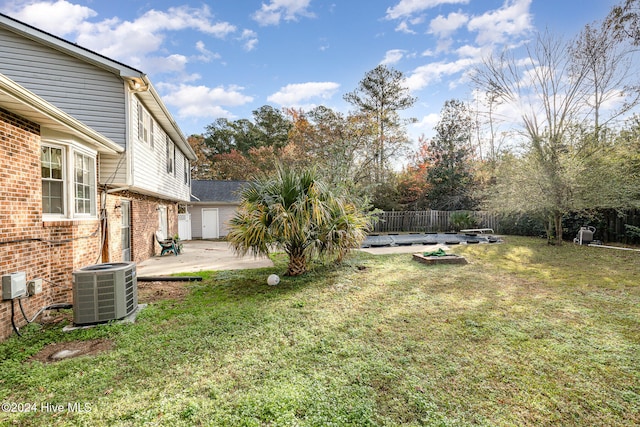 view of yard featuring central air condition unit, a patio area, and a pool