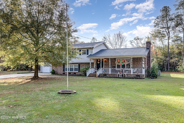 tri-level home with an outbuilding and a front lawn