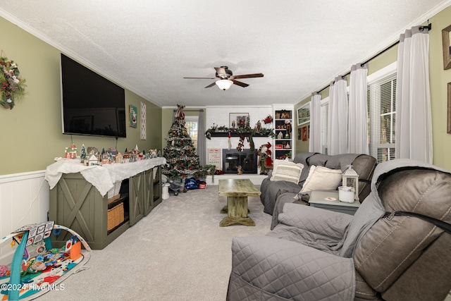 carpeted living room with a textured ceiling, ceiling fan, and ornamental molding