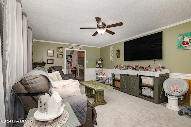 carpeted living room with ceiling fan, ornamental molding, and a textured ceiling