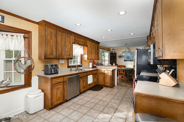 kitchen featuring crown molding, sink, light tile patterned floors, kitchen peninsula, and stainless steel appliances