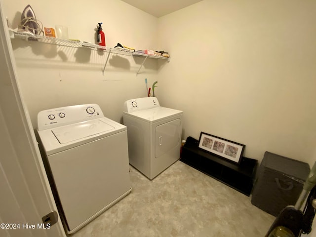 laundry area with separate washer and dryer and light carpet