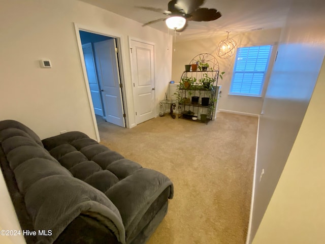 carpeted living room featuring ceiling fan