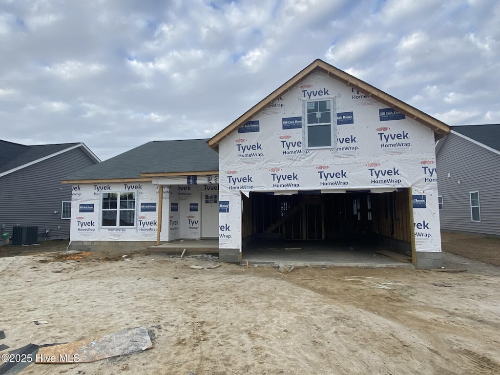 property in mid-construction featuring central AC unit