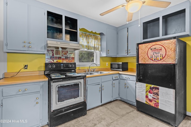 509 W 11th St, Southport, NC 28461 - kitchen featuring stainless steel microwave, a sink, fridge, electric range, and under cabinet range hood