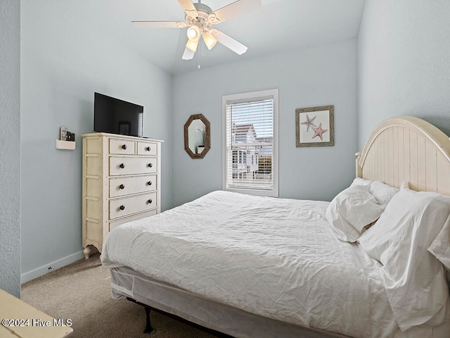 bedroom featuring light carpet and ceiling fan