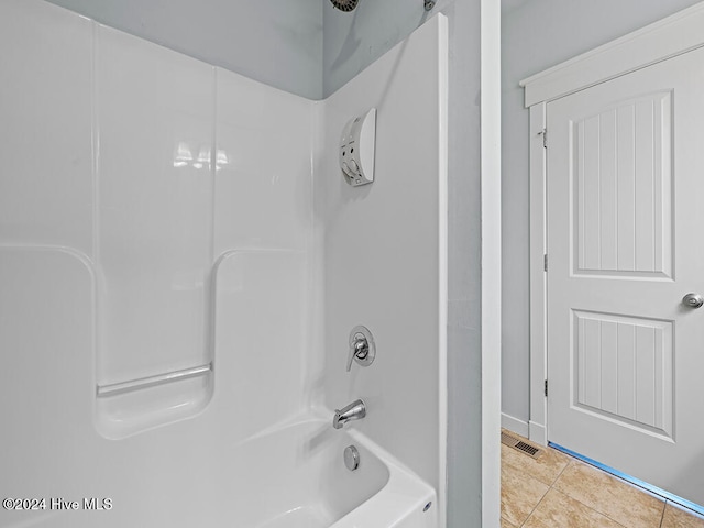 bathroom featuring tile patterned flooring and washtub / shower combination