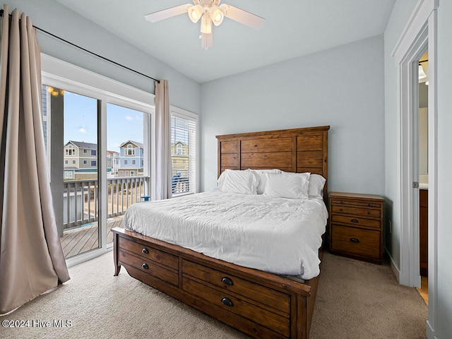 bedroom with ceiling fan, light carpet, and access to outside