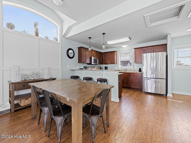 dining space featuring dark hardwood / wood-style flooring and plenty of natural light