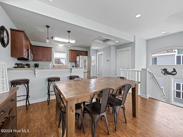 dining room with dark hardwood / wood-style flooring