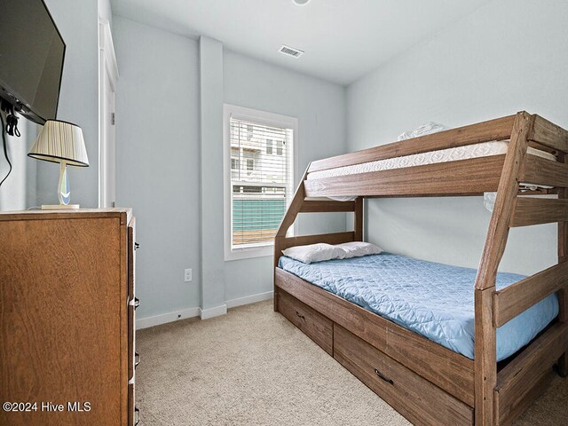 bedroom with light colored carpet