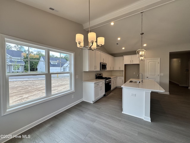 kitchen featuring an inviting chandelier, visible vents, a sink, vaulted ceiling, and stainless steel appliances