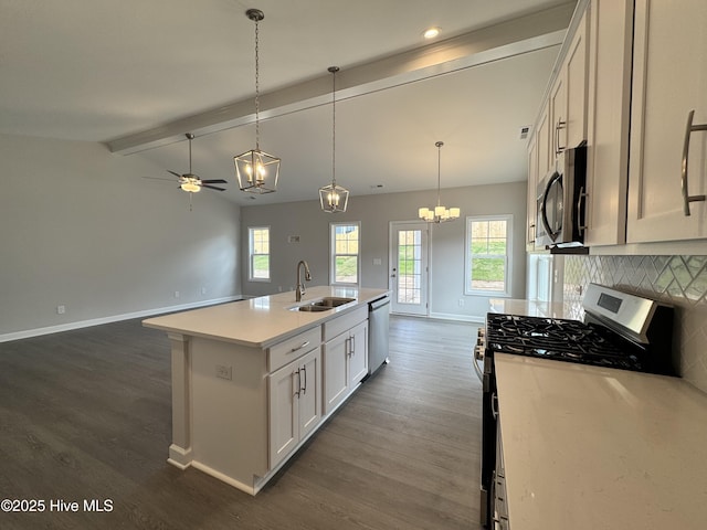 kitchen with baseboards, dark wood-style floors, stainless steel appliances, and a sink