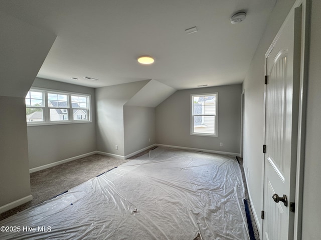 bonus room with carpet flooring, visible vents, and baseboards