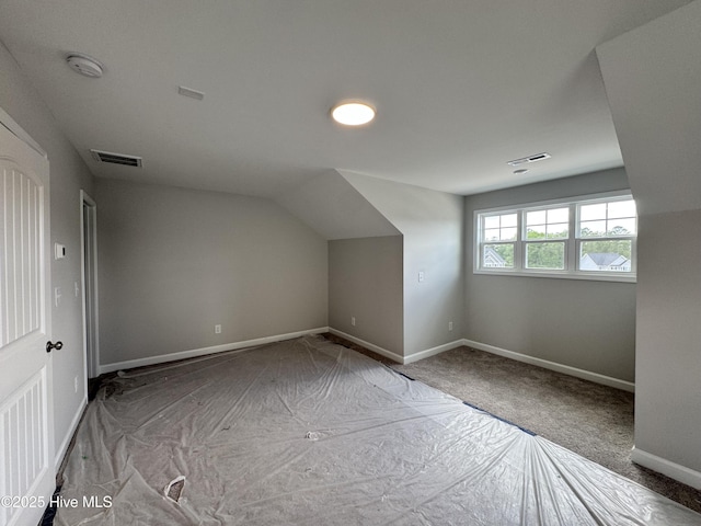 bonus room featuring visible vents, baseboards, and lofted ceiling