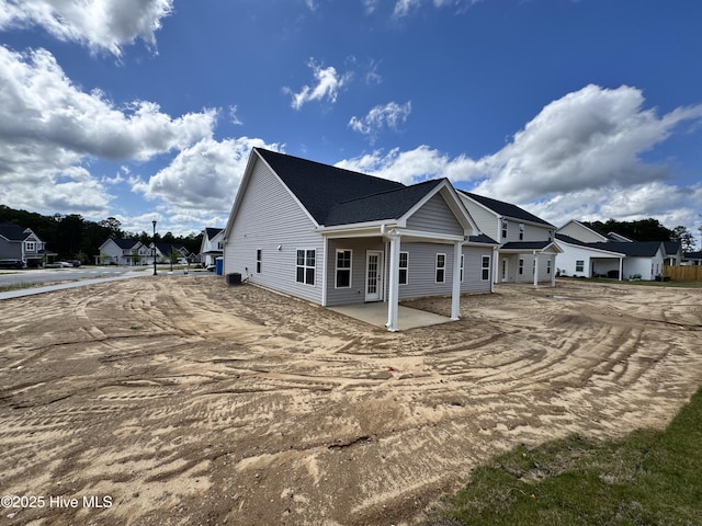 view of property exterior featuring a patio area and a residential view